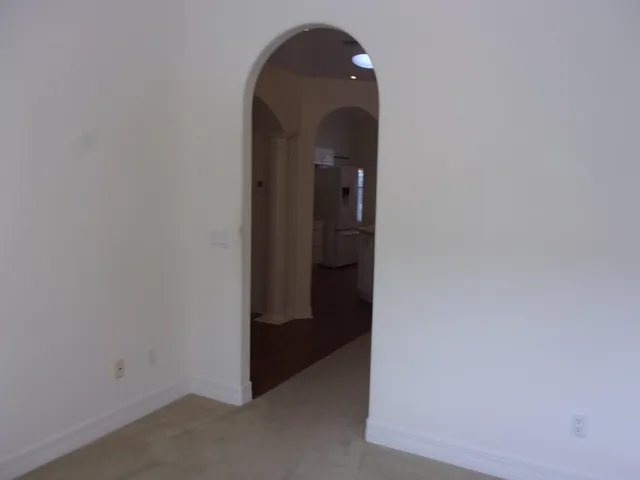a kitchen with stainless steel appliances a sink a window and cabinets