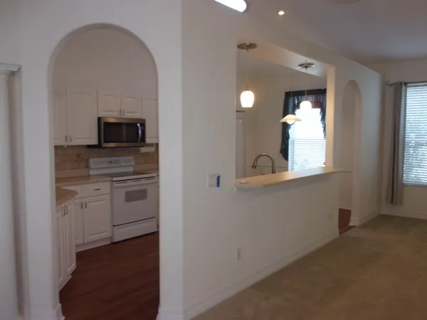 a kitchen with appliances a sink and cabinets