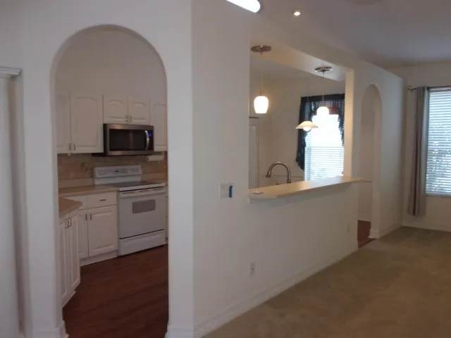 a kitchen with appliances a sink and cabinets