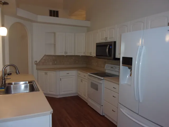 a view of a small space with wooden floor and a window