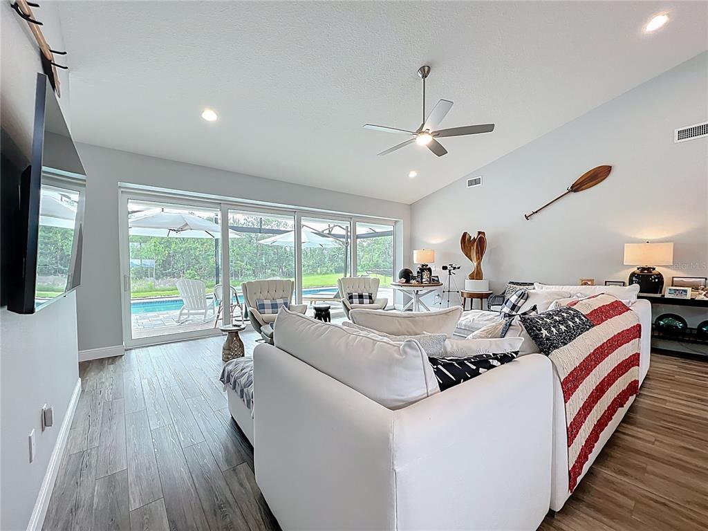10220 Bay Lake Road Groveland, FL 34736 - Photo 15 of 67 a living room with furniture and a large window