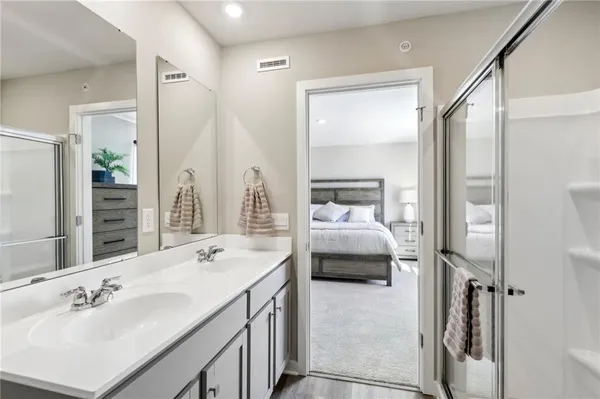 a en suite bathroom with a double vanity sink and a mirror