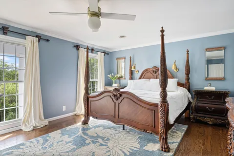a bedroom with a bed and wooden floor