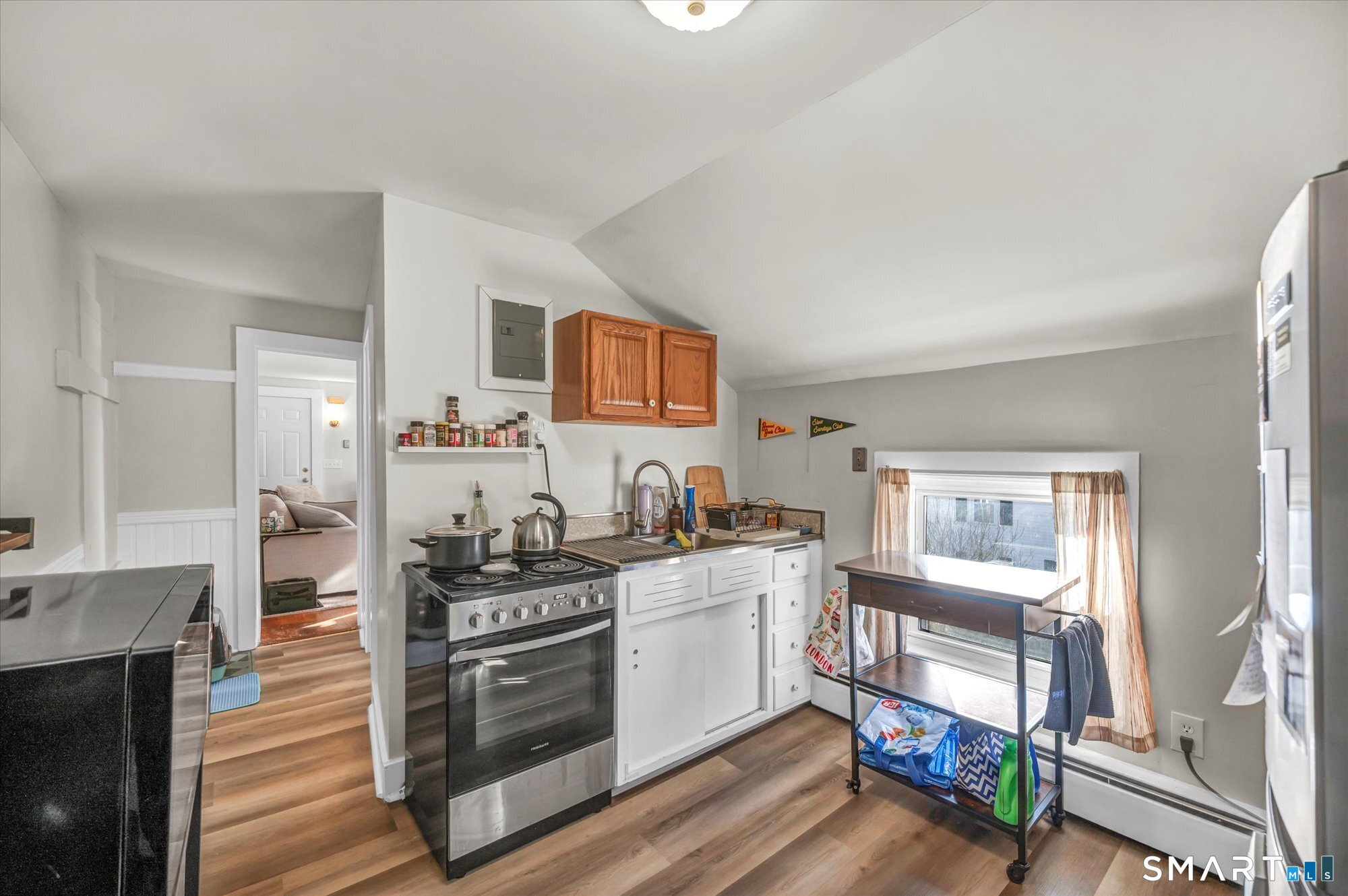 15 Mountain Street Vernon, CT 06066 - Photo 9 of 17 a kitchen with stainless steel appliances a stove top oven a sink a counter space and cabinets