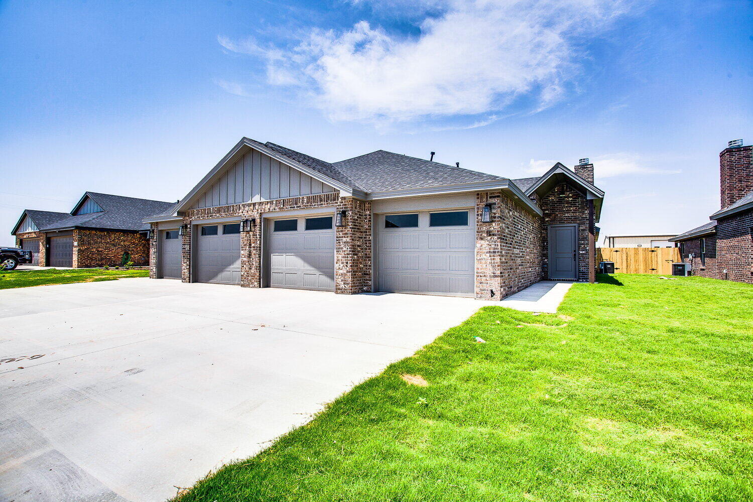 12106 Elkhart Avenue, Unit B Lubbock, TX 79424 - Photo 1 of 17 a front view of a house with a yard and garage