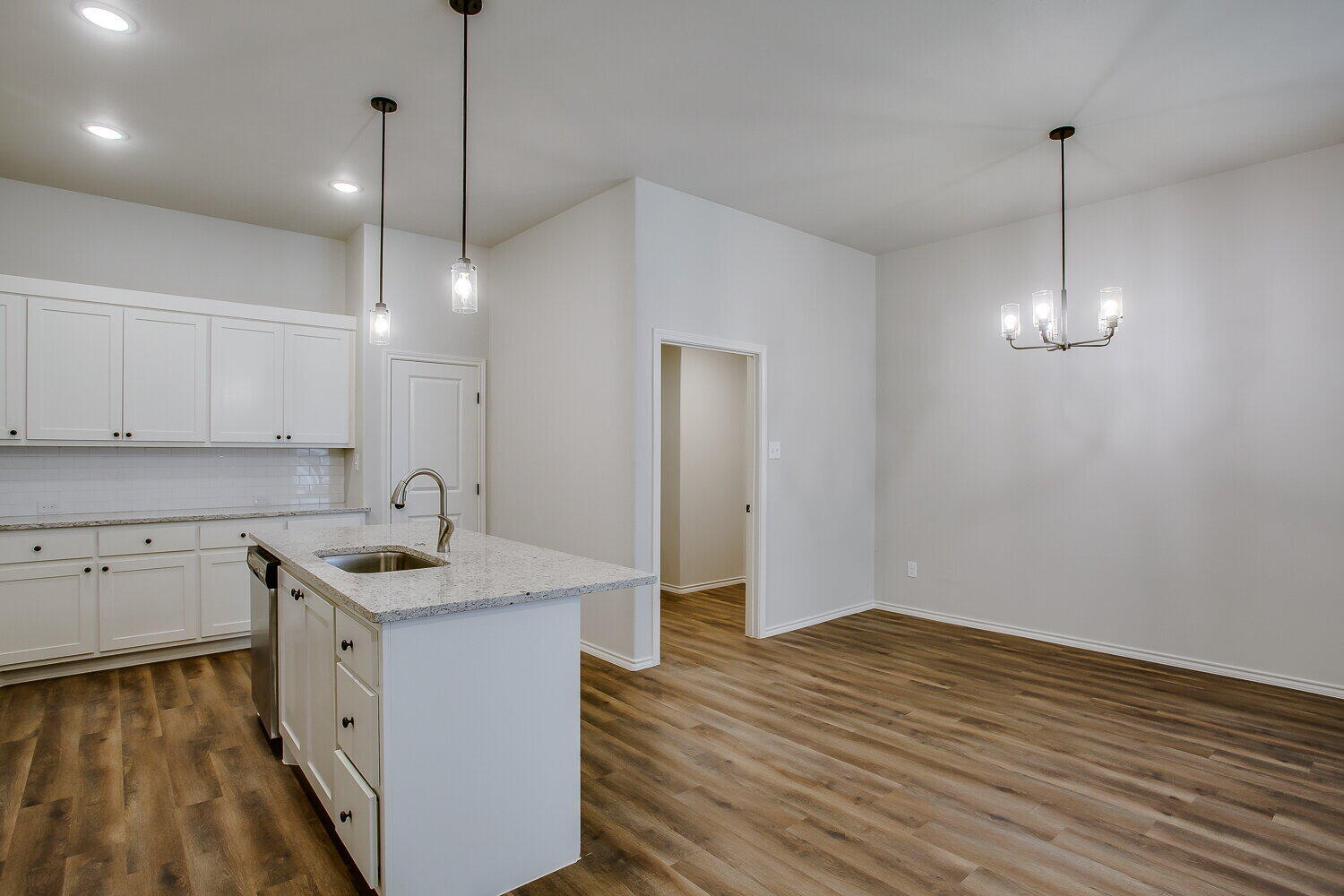 12106 Elkhart Avenue, Unit B Lubbock, TX 79424 - Photo 11 of 17 a kitchen with a sink stove and wooden floor