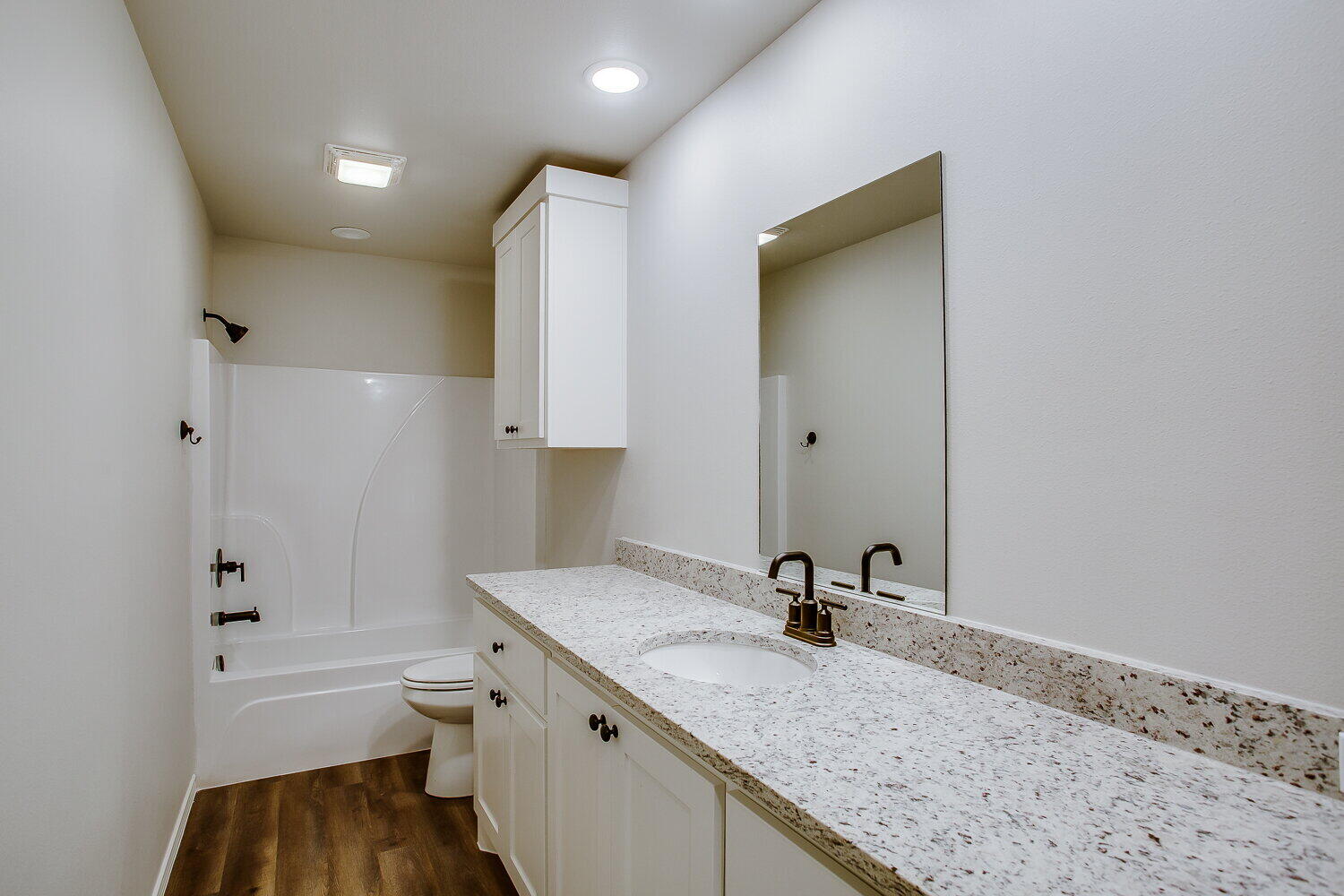 12106 Elkhart Avenue, Unit B Lubbock, TX 79424 - Photo 12 of 17 a bathroom with a granite countertop sink toilet and shower