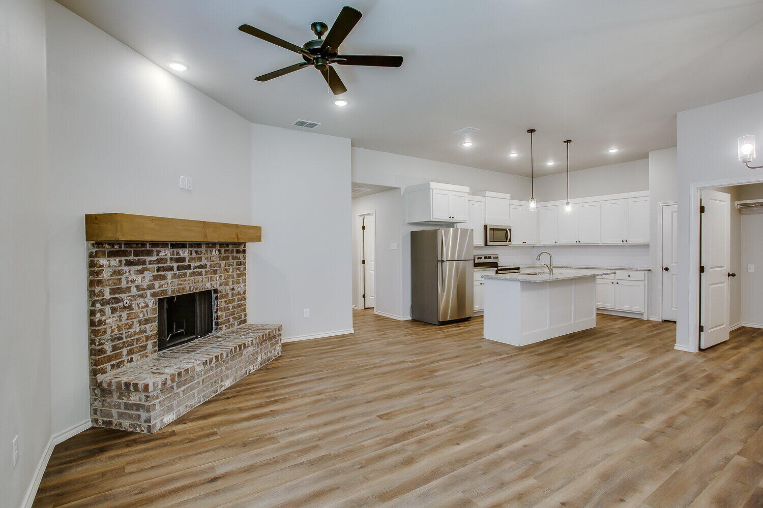 12106 Elkhart Avenue, Unit B Lubbock, TX 79424 - Photo 3 of 17 a view of kitchen with kitchen island wooden floor center island and stainless steel appliances