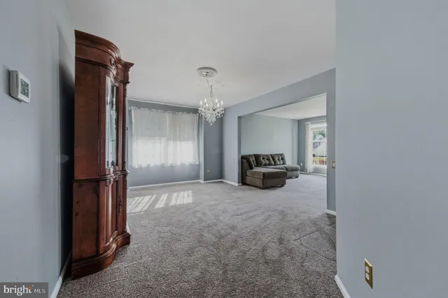 a view of a livingroom with a kitchen space and a window