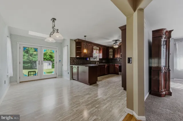a view of a kitchen with a sink and a refrigerator