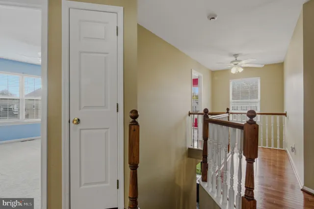 a view of a hallway with wooden floor and entryway