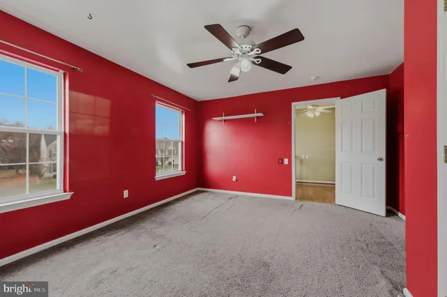 a view of a livingroom with a ceiling fan and window
