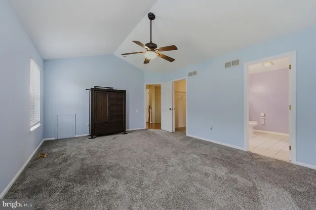 a view of a room with a ceiling fan
