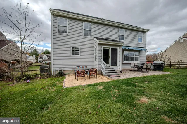 a front view of house with yard and outdoor seating