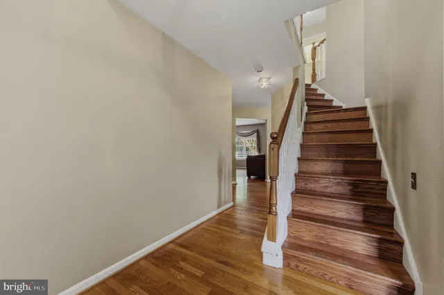 a view of entryway and gallery with wooden floor