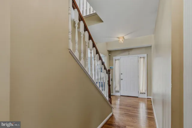 a view of a hallway with wooden floor and entryway