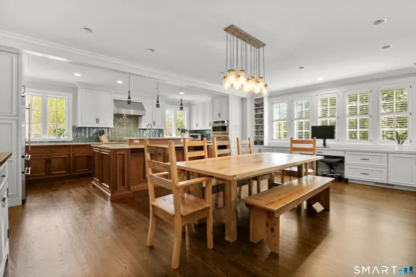 a view of a dining room with furniture and wooden floor