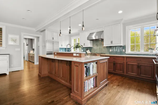 a kitchen with stainless steel appliances granite countertop a stove a sink and a refrigerator