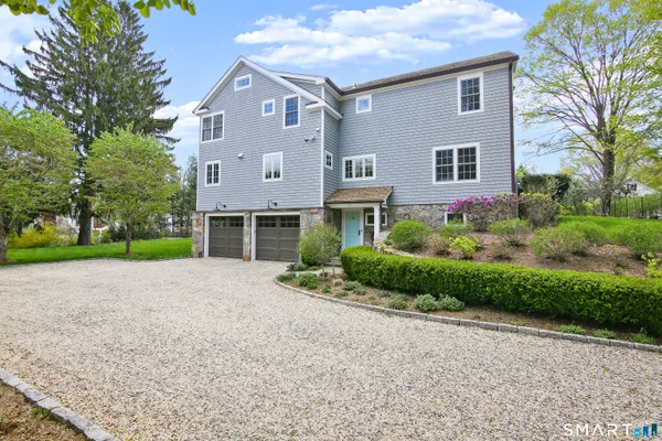 a front view of a house with a yard and a garage