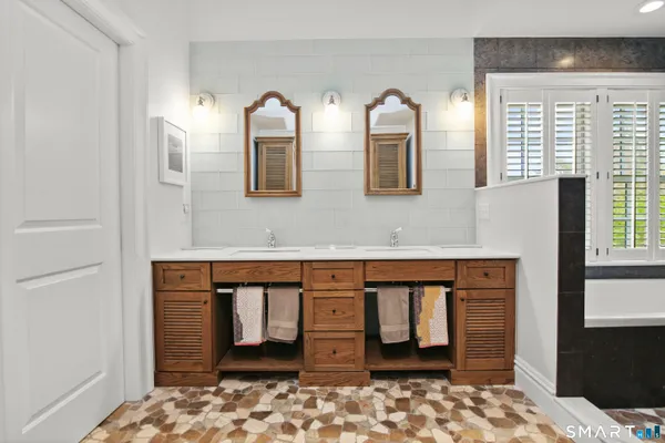 a bathroom with mirror and a sink