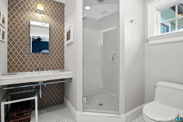 a bathroom with a toilet a sink and shower