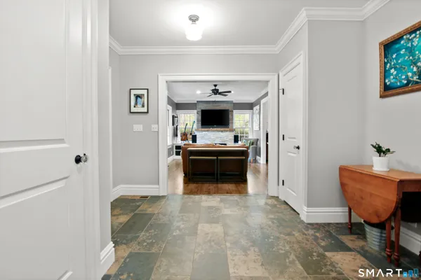 a view of a hallway with entryway and livingroom