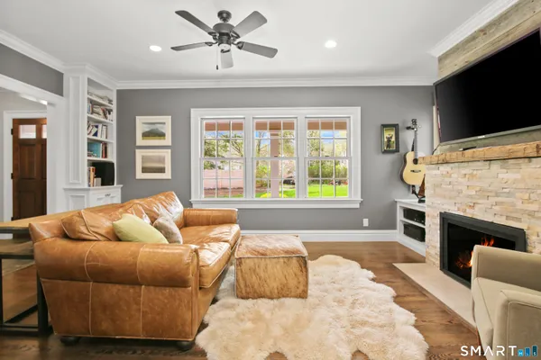 a living room with furniture fireplace and flat screen tv