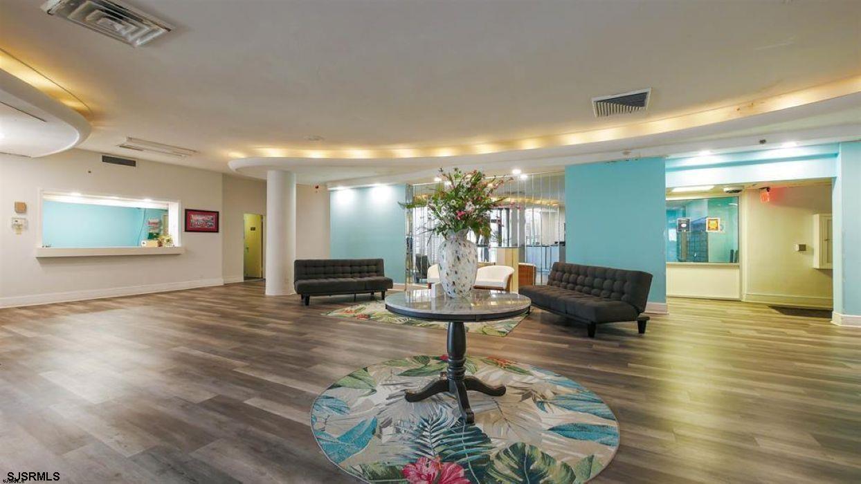 101 South Raleigh Avenue, Unit 320 Atlantic City, NJ 08401 - Photo 4 of 28 a living room with fireplace furniture and a wooden floor