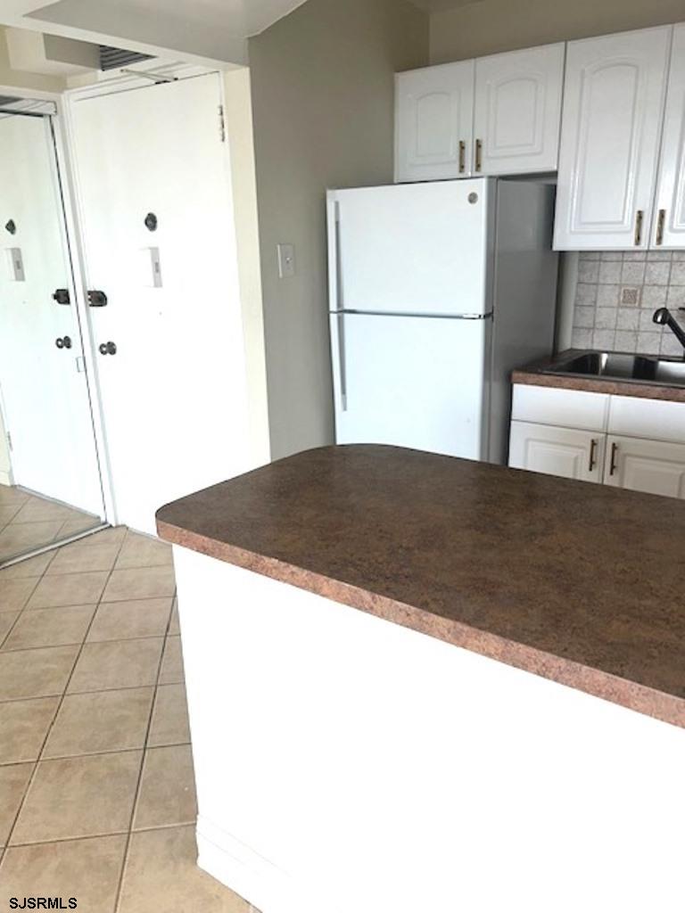 101 South Raleigh Avenue, Unit 320 Atlantic City, NJ 08401 - Photo 10 of 28 a white refrigerator freezer sitting in a kitchen