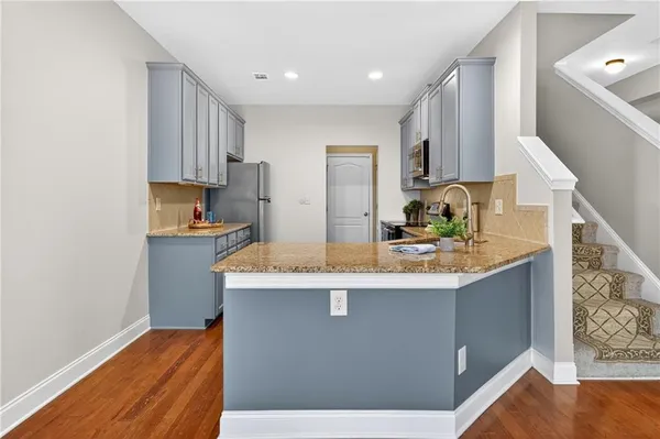 a kitchen with stainless steel appliances granite countertop a sink stove and refrigerator