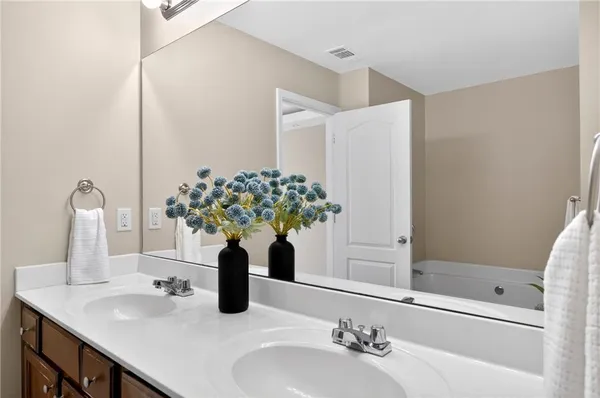 a bathroom with a sink a vanity and a mirror