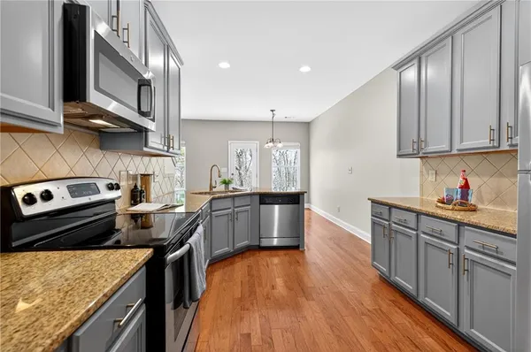 a kitchen with stainless steel appliances granite countertop a stove and a sink