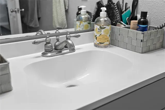 a bathroom with a sink and a mirror