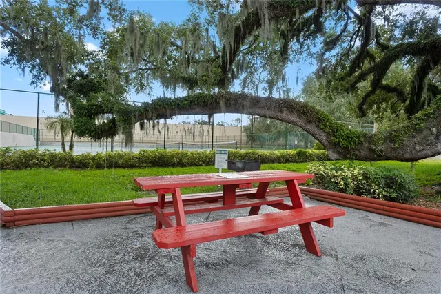 a backyard of a house with barbeque oven table and chairs