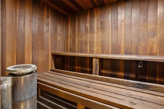 a large bathroom with a large mirror vanity and shower