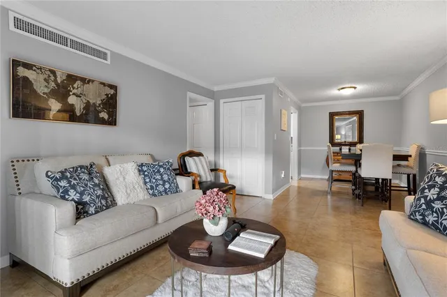 a living room with furniture or couch and a dining table