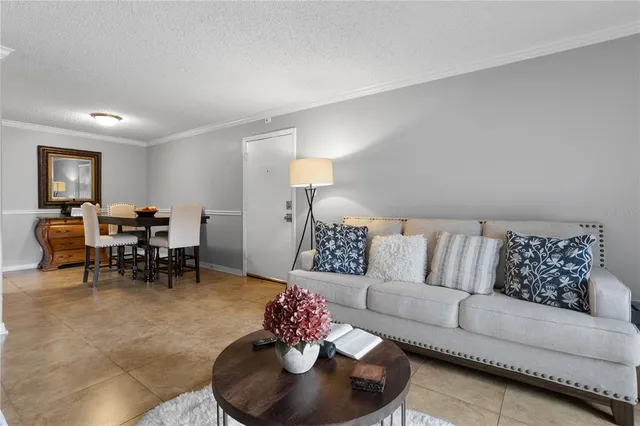 a living room with furniture and a dining room