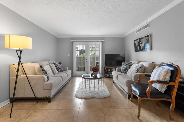 a living room with furniture and a lamp