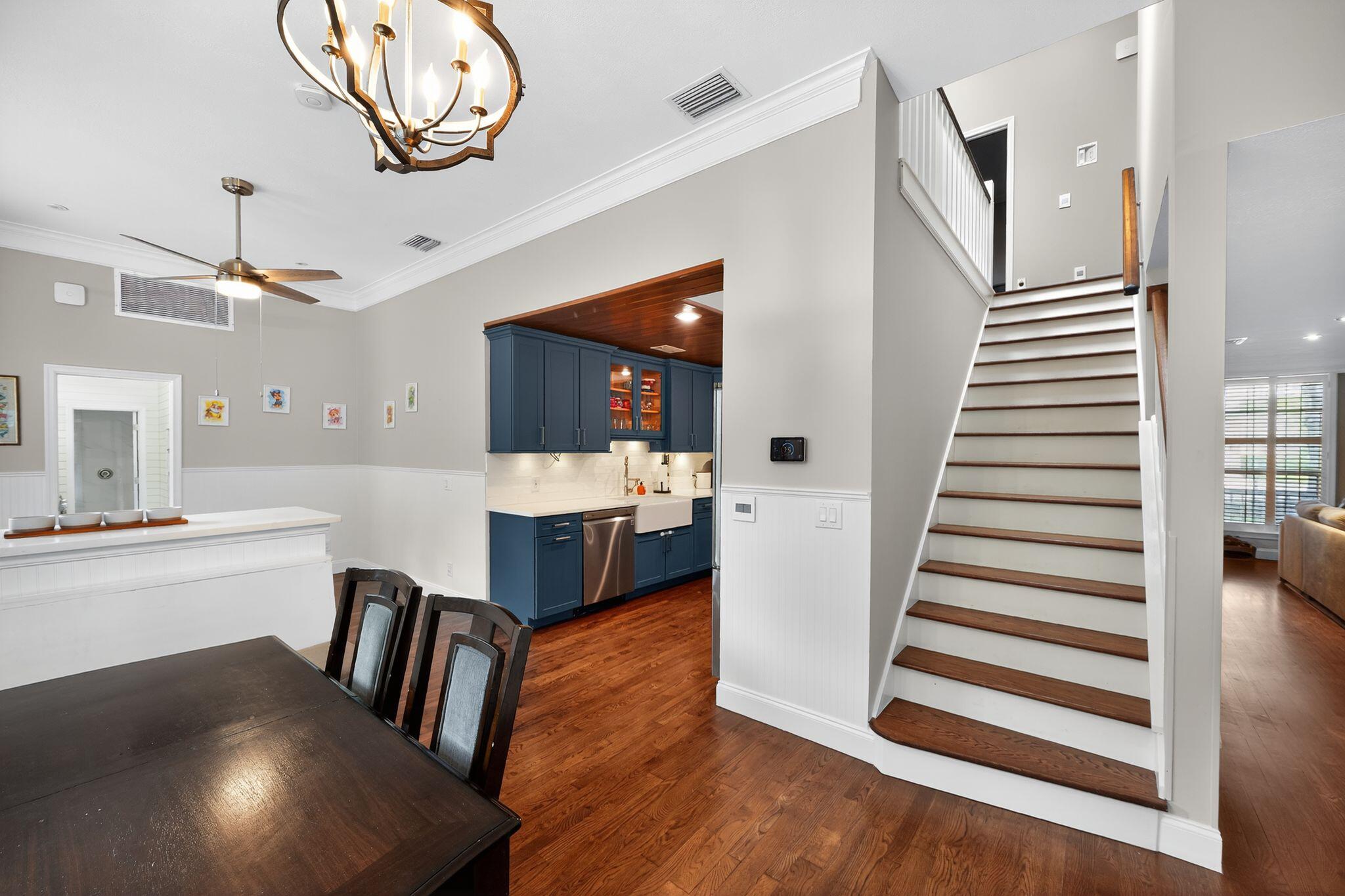 556 Meadow Wood Way Stuart, FL 34997 - Photo 13 of 57 a view of a hallway with dining room and wooden floor