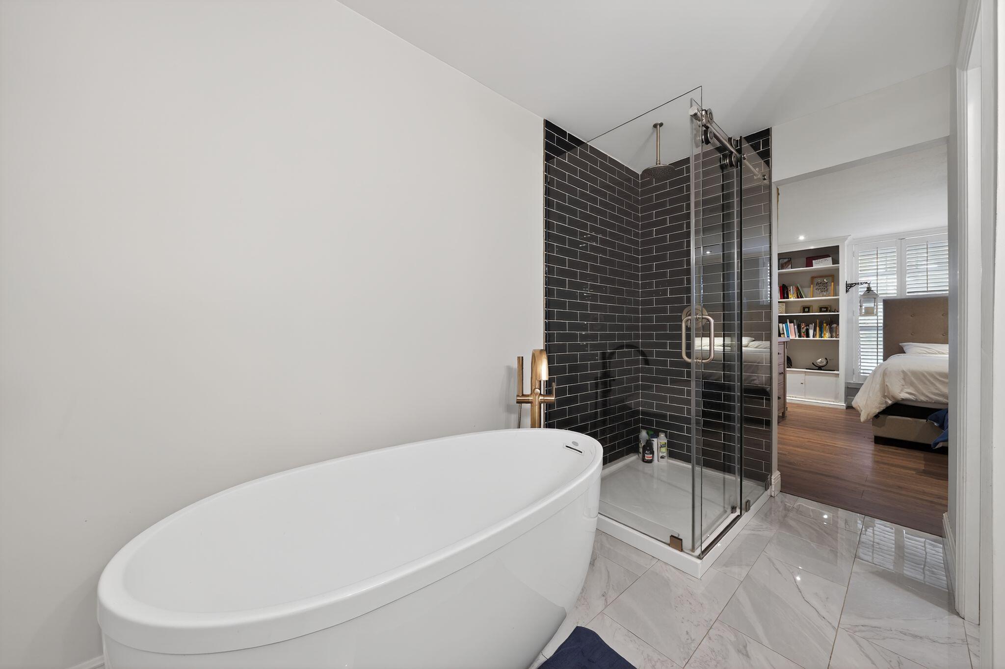 556 Meadow Wood Way Stuart, FL 34997 - Photo 16 of 57 a bathroom with a bathtub and shower