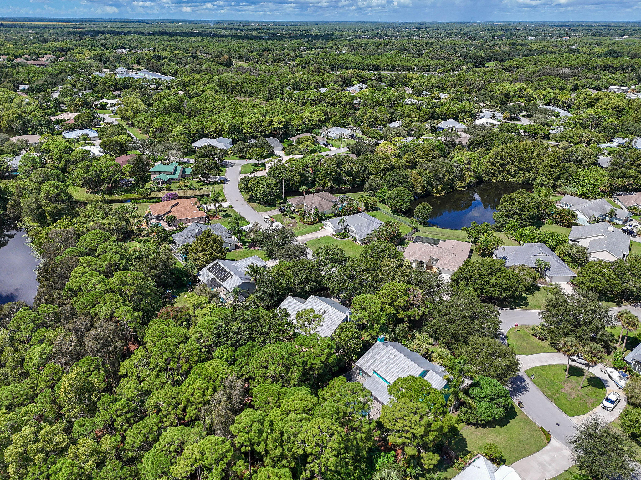 556 Meadow Wood Way Stuart, FL 34997 - Photo 44 of 57 an aerial view of residential house with outdoor space and trees all around