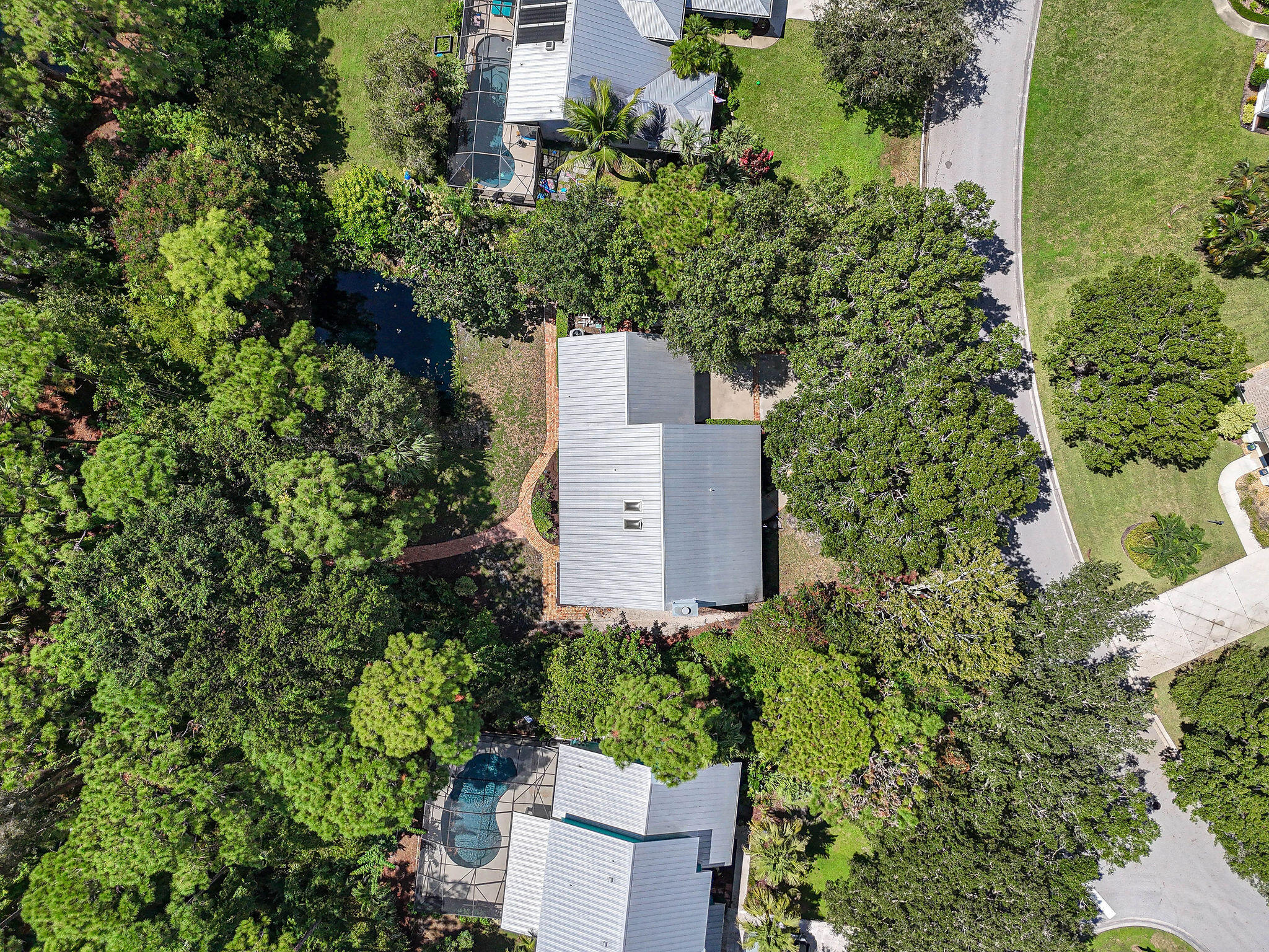 556 Meadow Wood Way Stuart, FL 34997 - Photo 50 of 57 an aerial view of a house with a yard and garden