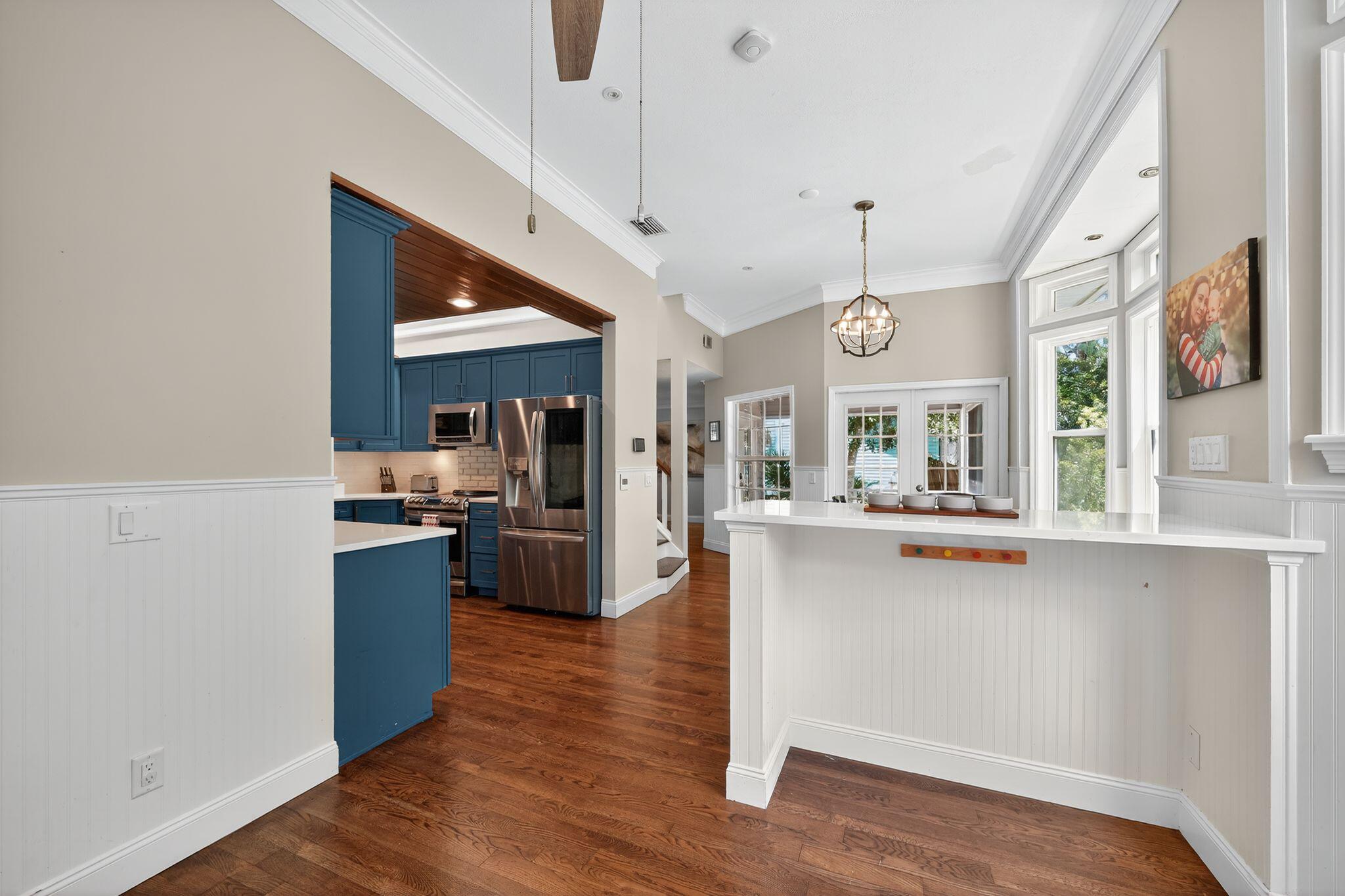 556 Meadow Wood Way Stuart, FL 34997 - Photo 9 of 57 a large kitchen with cabinets wooden floor and stainless steel appliances