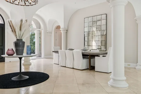 a living room with fireplace furniture and a chandelier