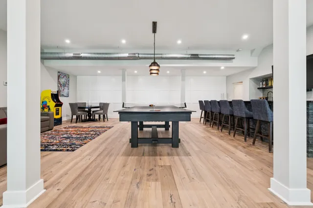 a room with a table chairs and a flat screen tv