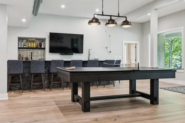 a kitchen with stainless steel appliances granite countertop a refrigerator a sink dishwasher and a stove with wooden floor