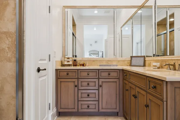 a spacious bedroom with a large bed and a chandelier
