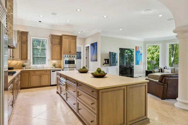 a kitchen with granite countertop cabinets stainless steel appliances and a counter space