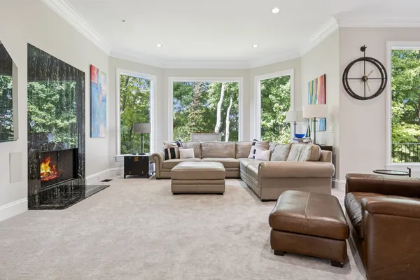 a dining room with furniture a chandelier and wooden floor