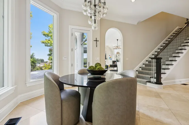 a living room with fireplace furniture and a chandelier